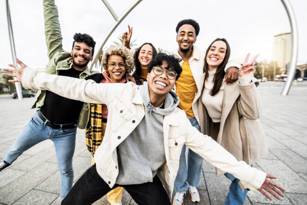 "Group of international graduates smiling together in the UK, representing opportunities to switch from the Graduate Route to Skilled Worker visa under 2025 rules."