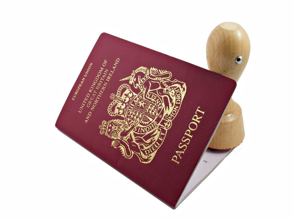 UK passport with an immigration stamp, representing visa application and refusal concerns.