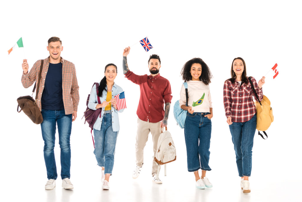 A diverse group of young adults from different countries holding national flags and carrying backpacks, symbolising international applicants for the UK Skilled Worker visa in 2025