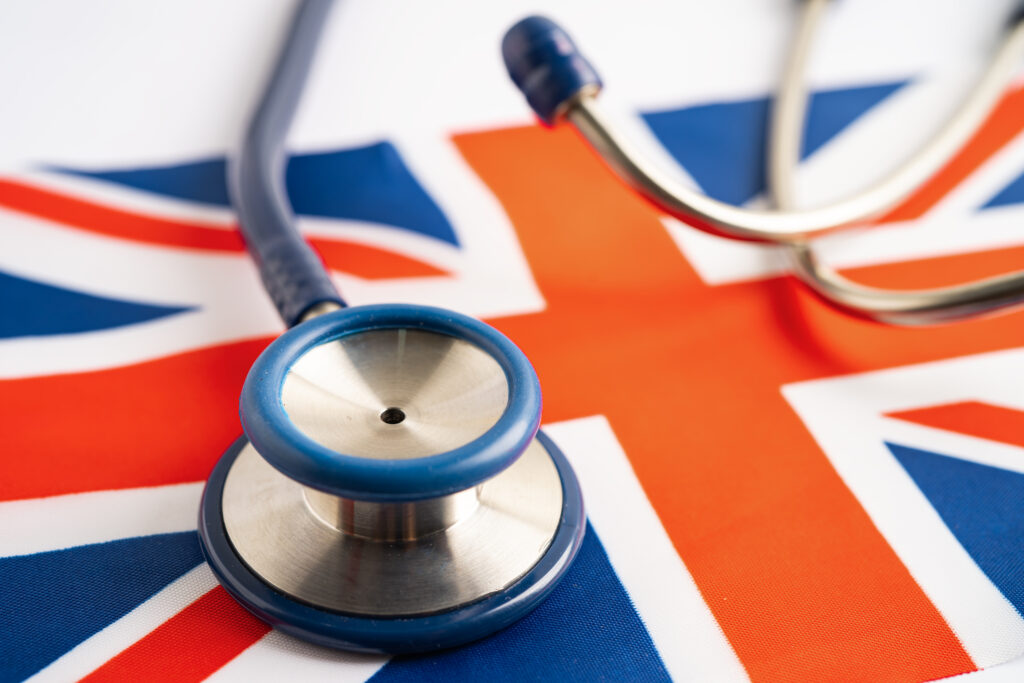 Stethoscope placed on the Union Jack flag symbolising NHS access for skilled workers in the UK.