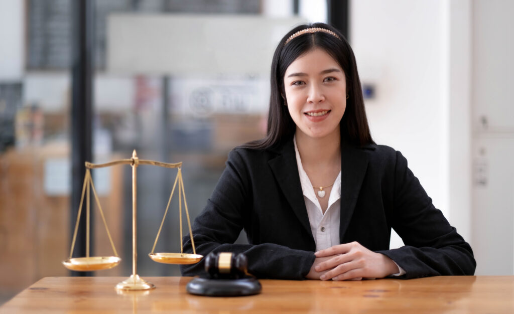 A professional reviewing Skilled Worker visa documents on a laptop, with GOV.UK guidance open on screen, symbolising the choice between self-apply and using an immigration lawyer in 2025.