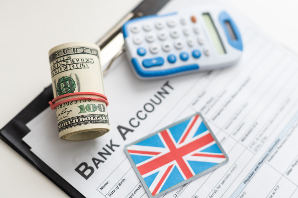 Skilled Worker visa holder opening a UK bank account with passport, BRP card, and proof of address documents on a desk.