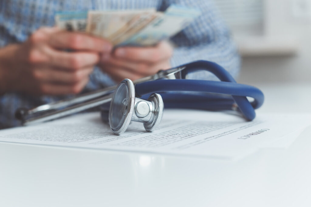 A Skilled Worker visa holder reviewing healthcare options in the UK, comparing NHS services covered by the Immigration Health Surcharge with private healthcare insurance plans in 2025.