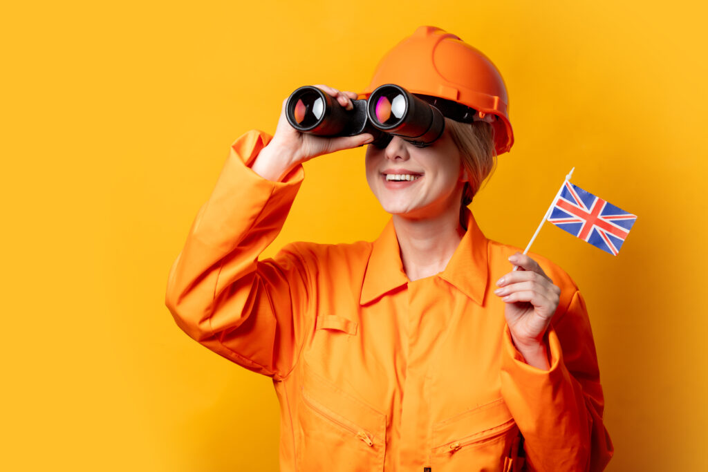 Professional worker in a modern UK office reviewing documents, symbolising Skilled Worker visa job role changes with the same employer.