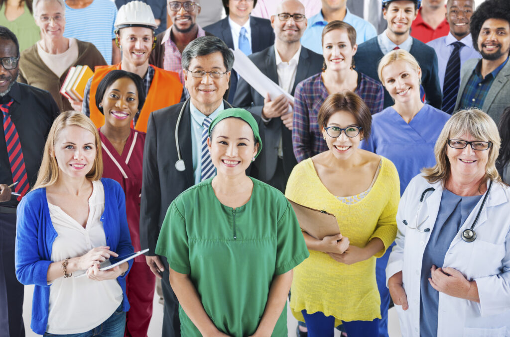 Healthcare professionals from diverse backgrounds working together in a modern UK hospital, symbolising international recruitment through the Skilled Worker visa route in 2025.