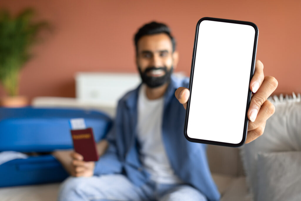 A new migrant in the UK using a smartphone to open a digital-only bank account, with app icons like Monzo and Revolut visible on the screen.