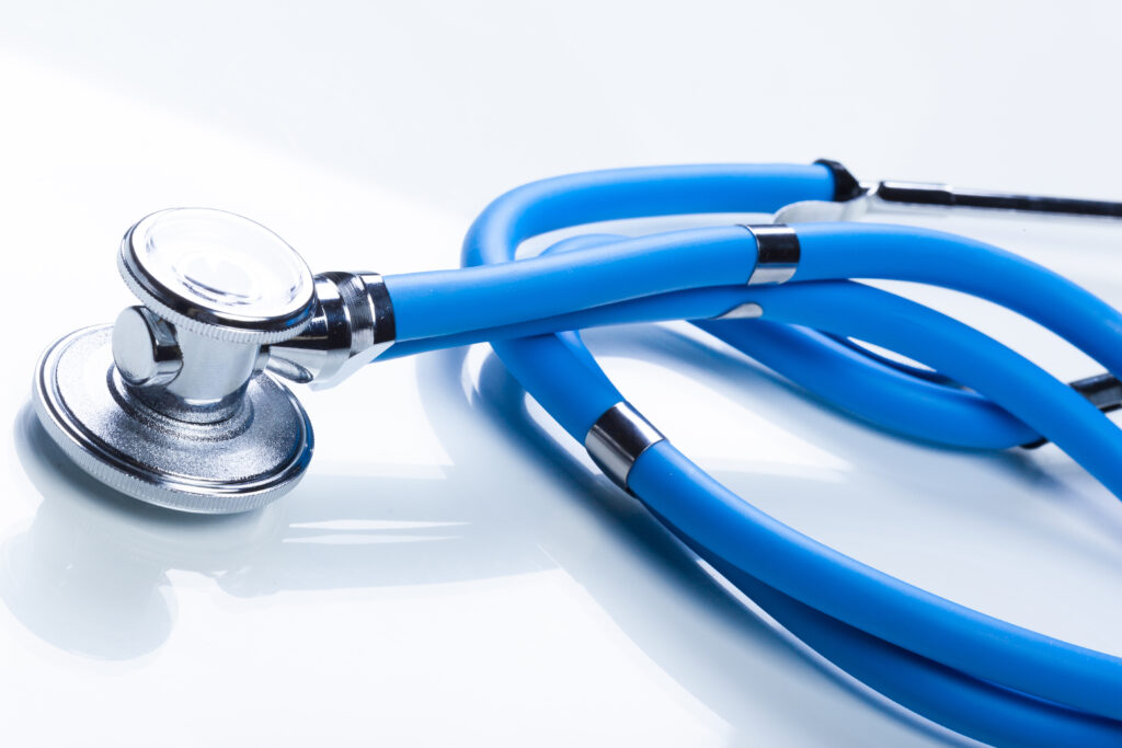 A doctor reviewing medical documents with a Skilled Worker visa applicant during a routine health check in the UK.