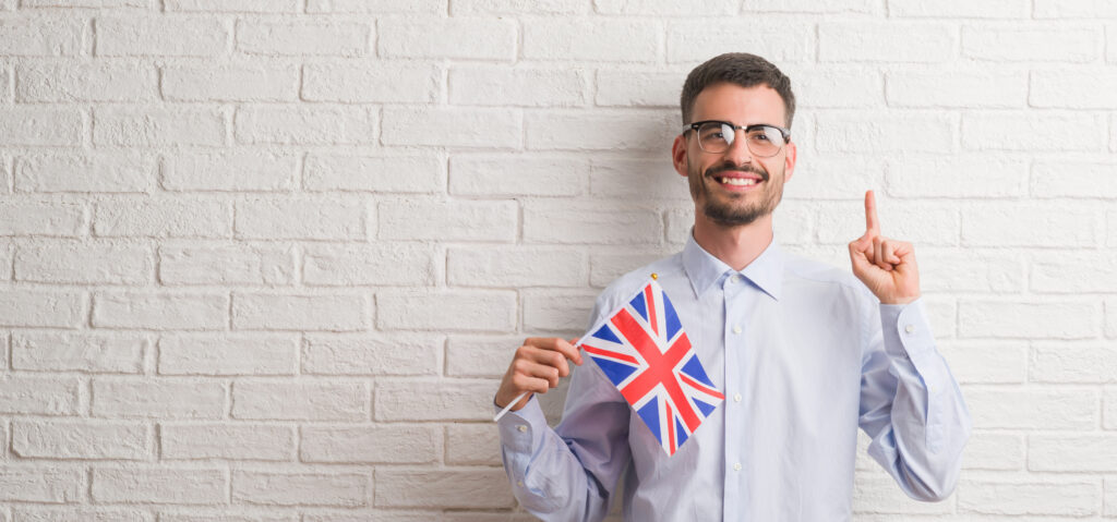 A professional applicant preparing for a UK Skilled Worker visa interview, reviewing documents and practising answers in front of a laptop.